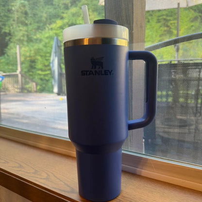 Stanley 40oz stainless steel tumbler with handle and straw – leakproof, vacuum insulated travel mug for hot and cold drinks available at Trendz Inn Pakistan.